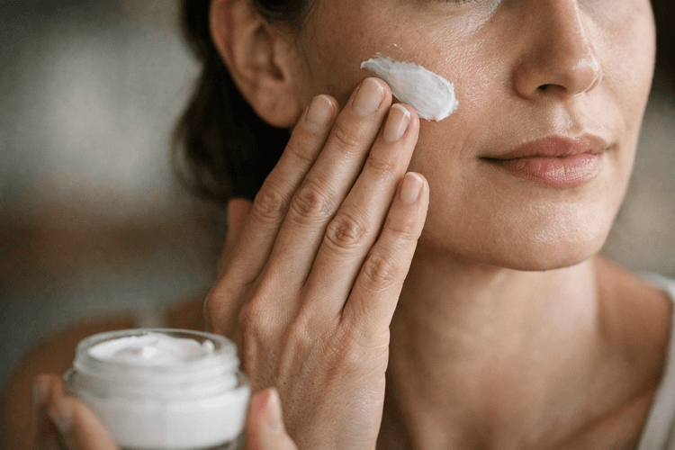 Person applying collagen cream to their face